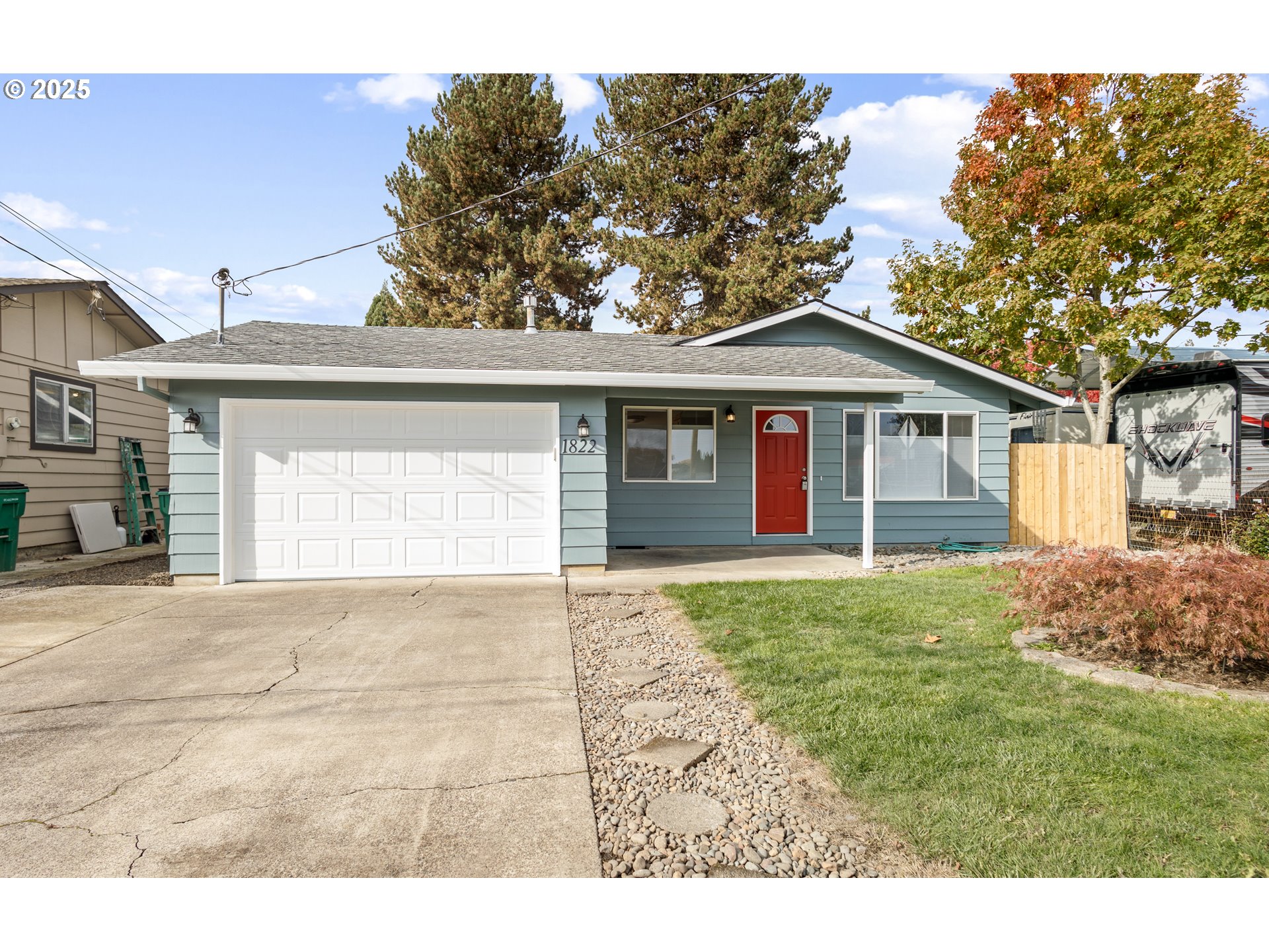 1822 Hawthorne Street Forest Grove, OR 97116 - Photo 2 of 18 a view of a yard in front of a house with large trees