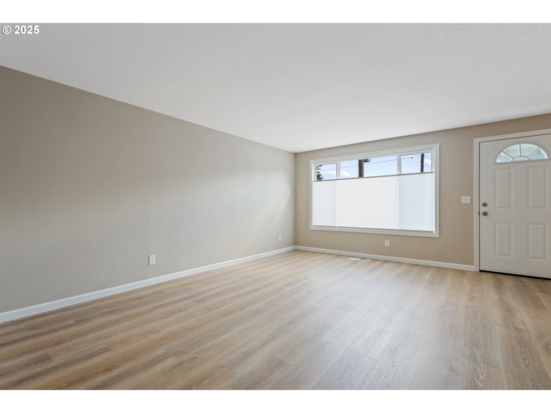 1822 Hawthorne Street Forest Grove, OR 97116 - Photo 9 of 18 a view of an empty room with wooden floor and a window