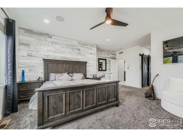 a spacious bathroom with a granite countertop sink and a mirror
