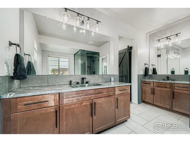 a bathroom with a granite countertop sink a large mirror and a
