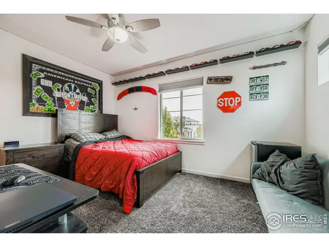a bedroom with furniture and a flat screen tv