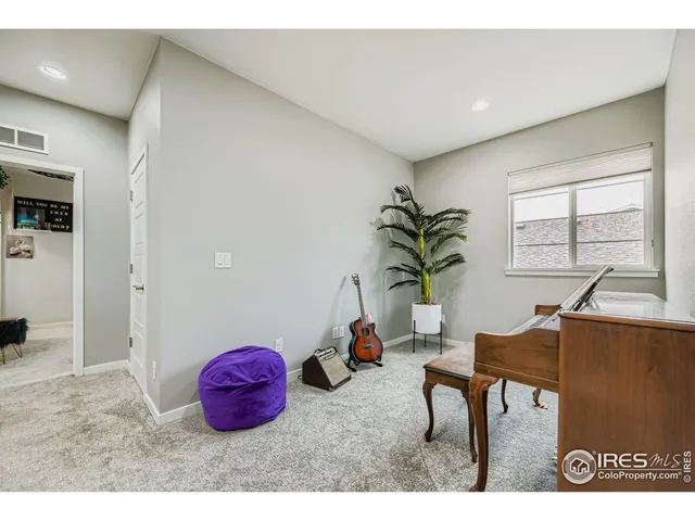 a living room with furniture a window and a potted plant