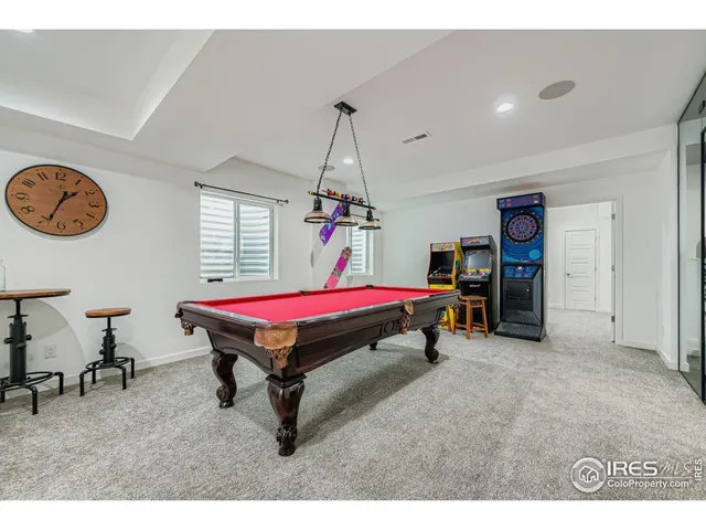 a living room with furniture and a ceiling fan