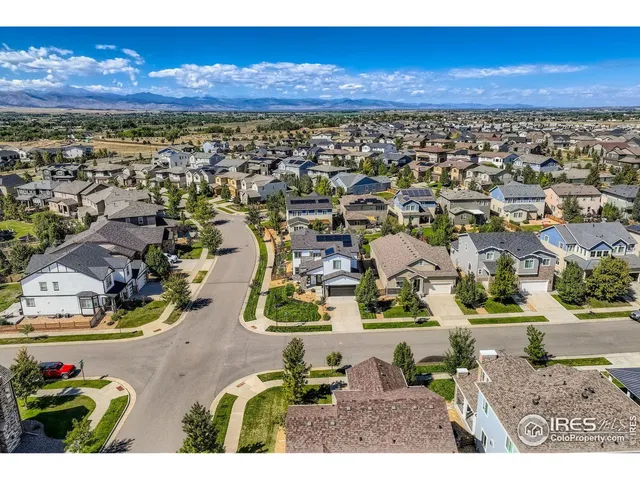 an aerial view of a house with garden space and outdoor seating