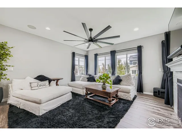 a living room with furniture ceiling fan and a window