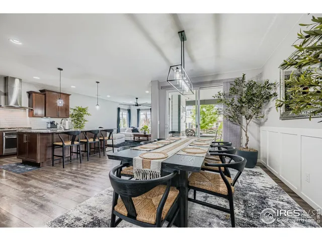 a view of a dining room with furniture and a chandelier