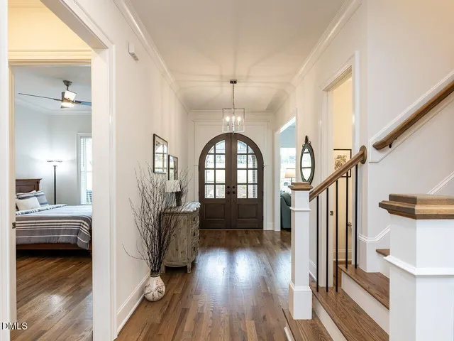 a view of a hallway with wooden floor and cabinet