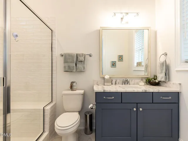 a view of a deck with wooden floor and fence with a large window