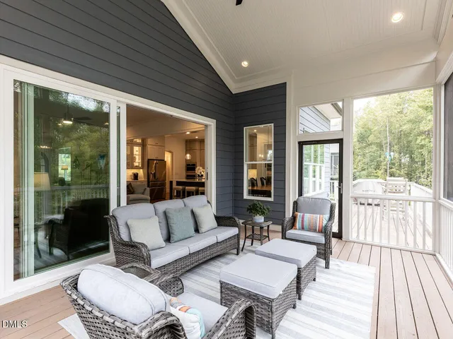 a view of a patio with couches chairs and a yard