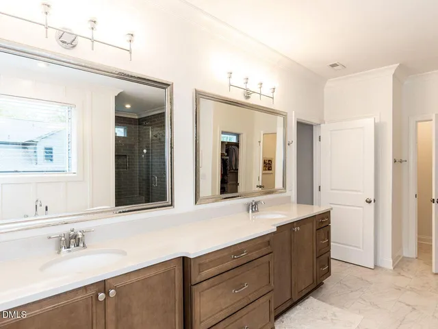 a bathroom with a granite countertop sink a toilet a mirror and bathtub