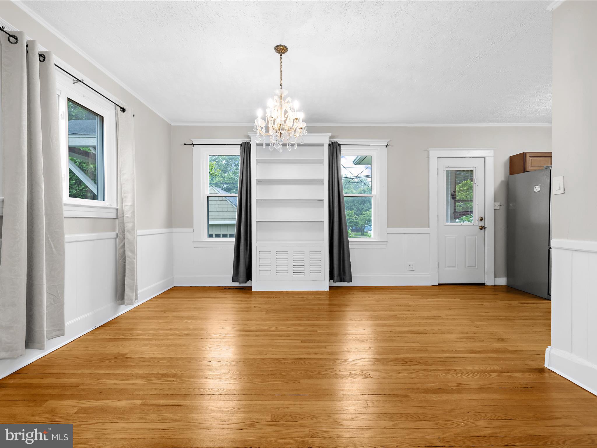 112 Homewood Road Linthicum Heights, MD 21090 - Photo 14 of 44 a view of empty room with wooden floor and windows