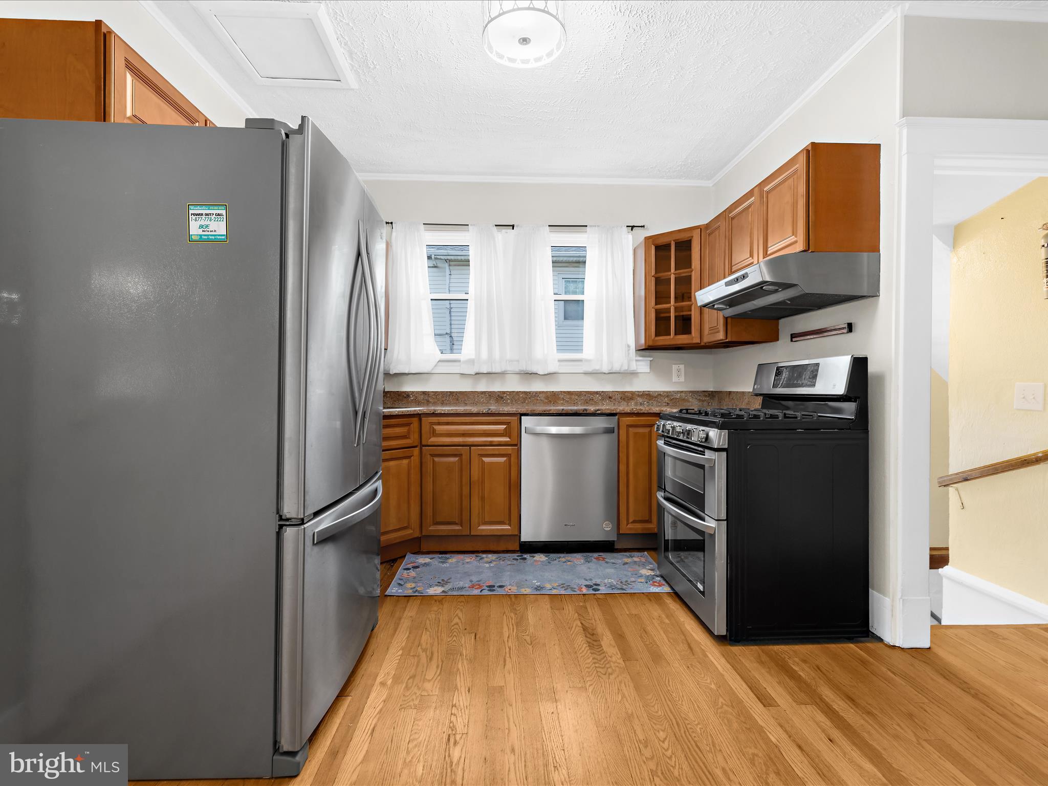 112 Homewood Road Linthicum Heights, MD 21090 - Photo 15 of 44 a kitchen with stainless steel appliances granite countertop a refrigerator a stove and a sink