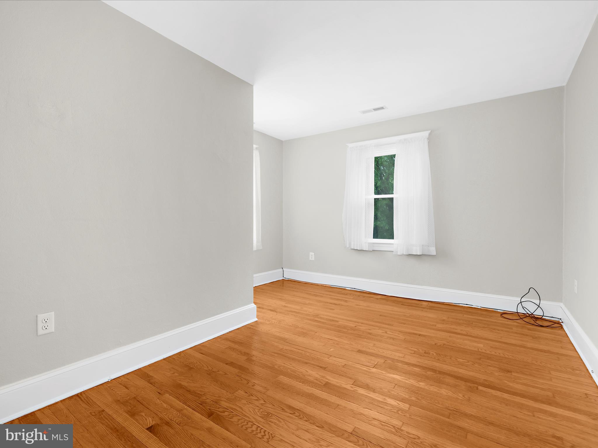 112 Homewood Road Linthicum Heights, MD 21090 - Photo 26 of 44 a view of empty room with wooden floor and fan