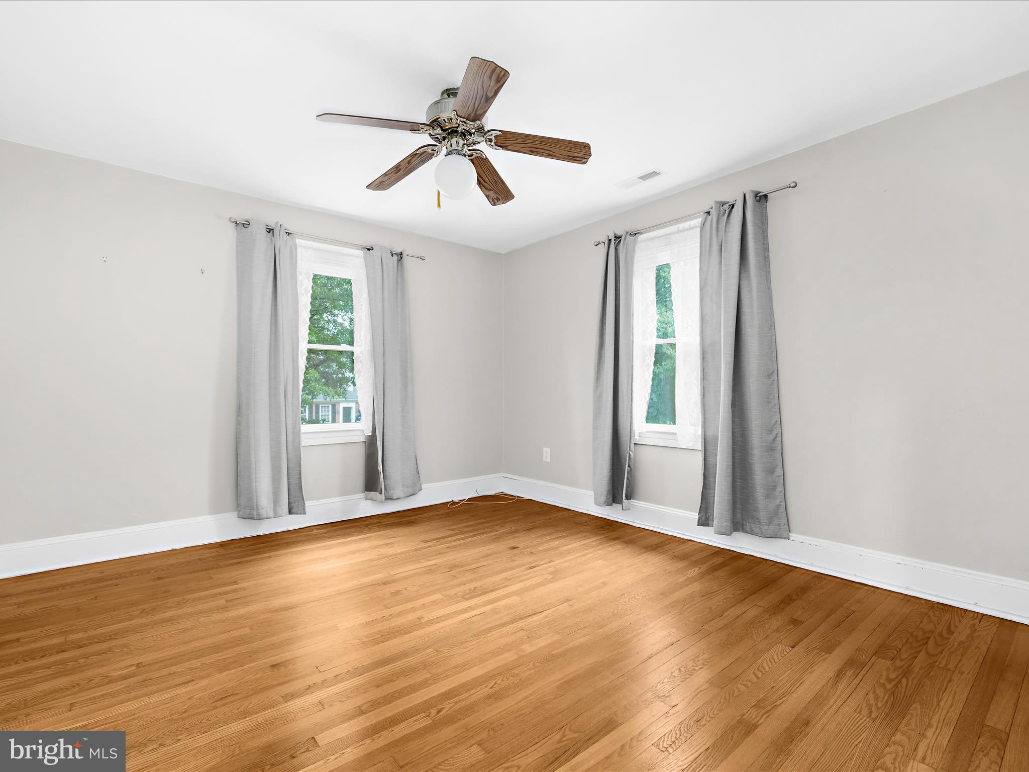 112 Homewood Road Linthicum Heights, MD 21090 - Photo 29 of 44 a view of an empty room with wooden floor and a window