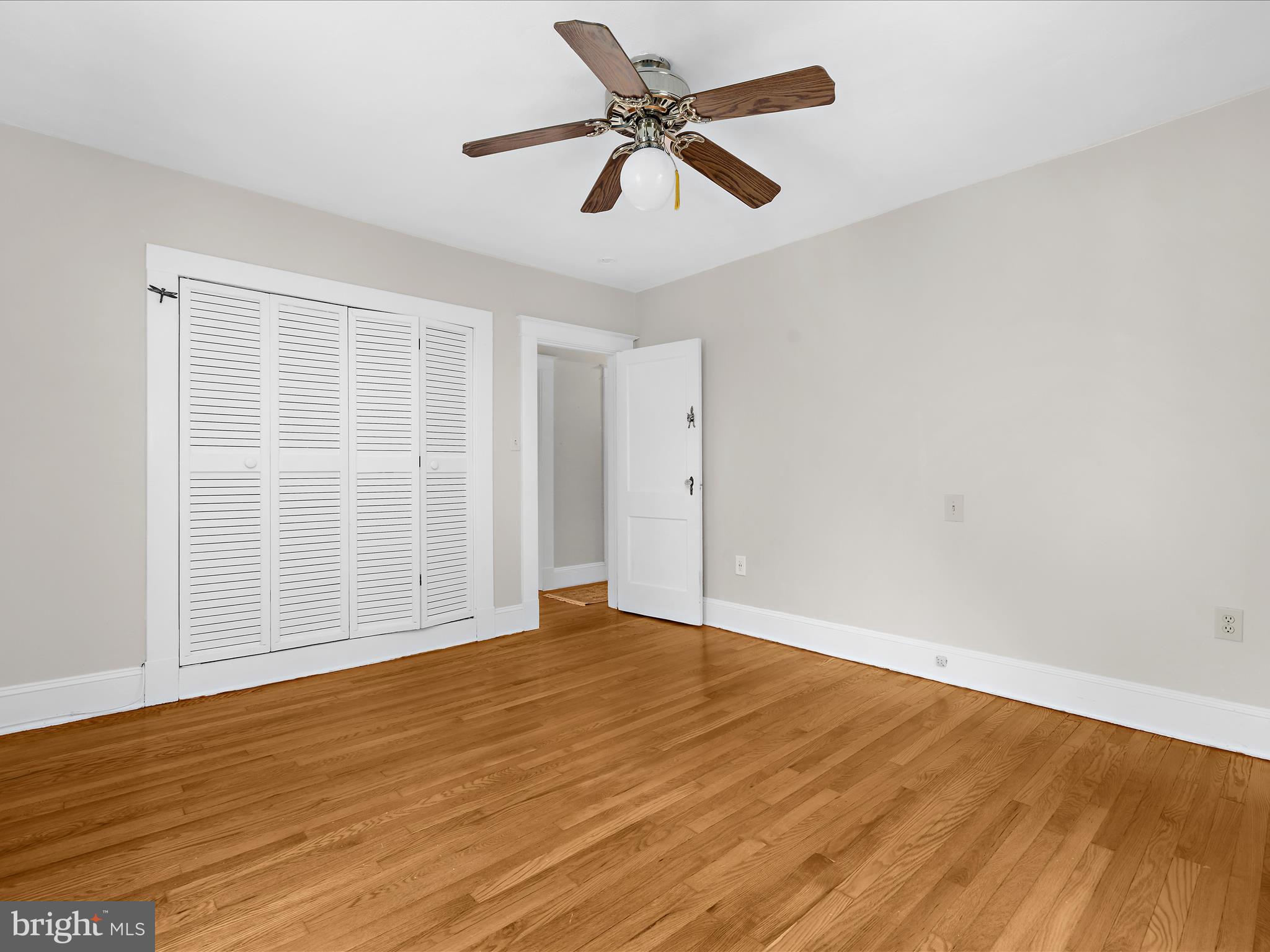 112 Homewood Road Linthicum Heights, MD 21090 - Photo 30 of 44 an empty room with wooden floor fan and windows