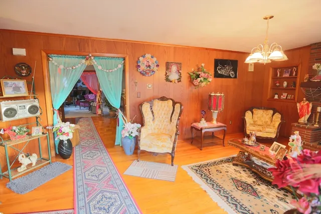 a view of a dining room with furniture chandelier and wooden floor