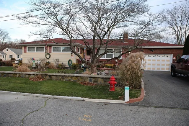 a front view of a house with a garden