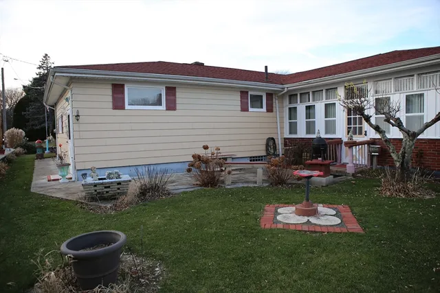 a backyard of a house with table and chairs