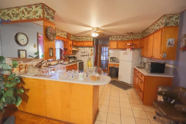 a living room with table or couch and a potted plant