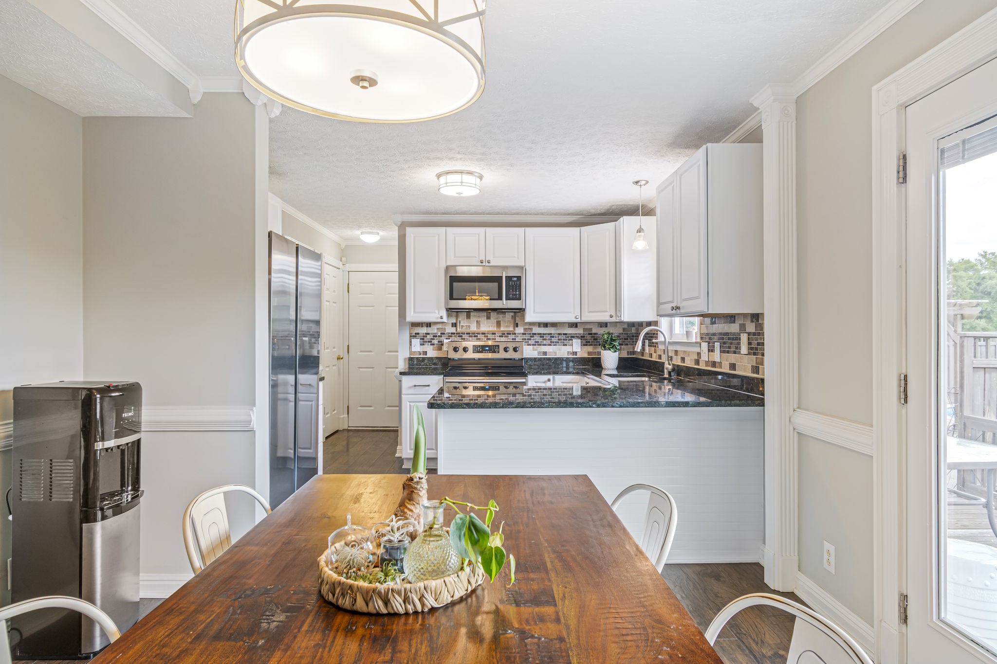3137 Southall Road Franklin, TN 37064 - Photo 12 of 51 a kitchen with stainless steel appliances granite countertop a refrigerator a stove a sink dishwasher with a dining table and chair