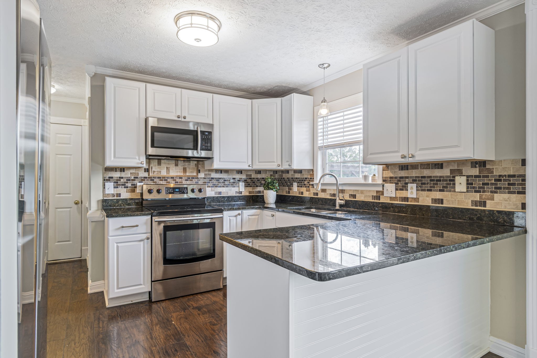 3137 Southall Road Franklin, TN 37064 - Photo 14 of 51 a kitchen with kitchen island granite countertop a sink cabinets and stainless steel appliances