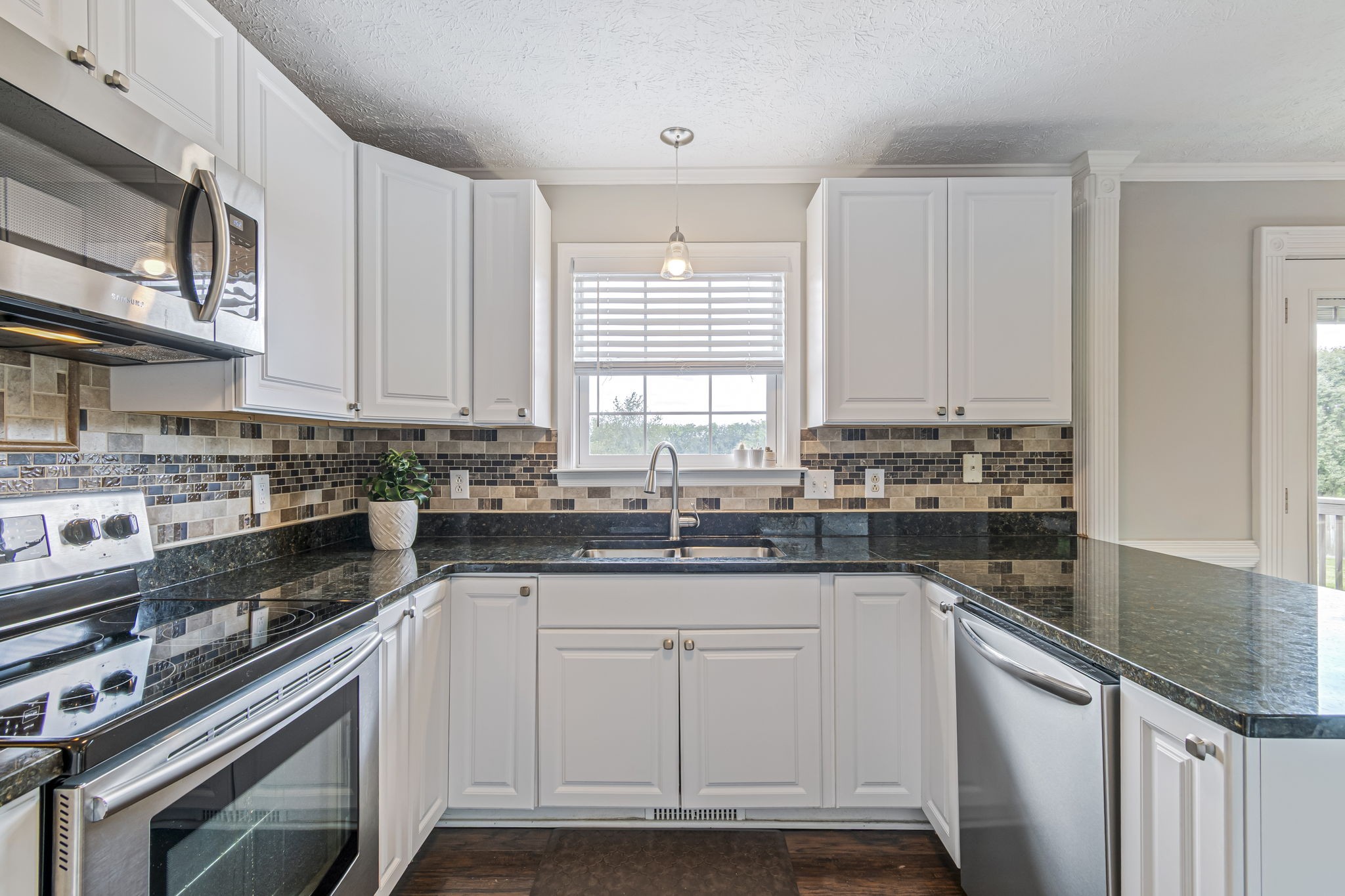 3137 Southall Road Franklin, TN 37064 - Photo 15 of 51 a kitchen with granite countertop white cabinets and white appliances