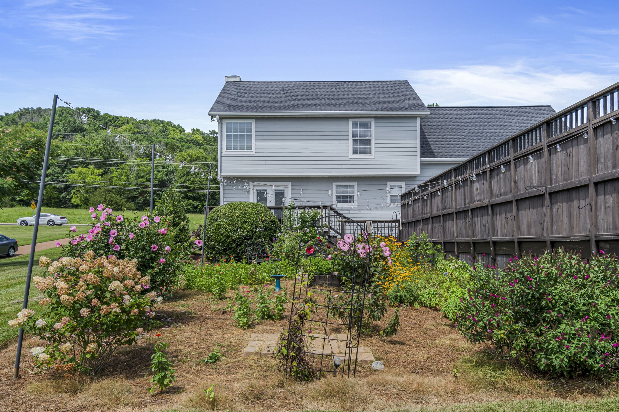 3137 Southall Road Franklin, TN 37064 - Photo 42 of 51 a view of a house with wooden walls and bench in a yard