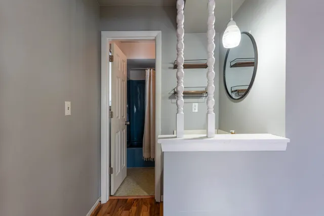 a view of a livingroom with furniture and mirror
