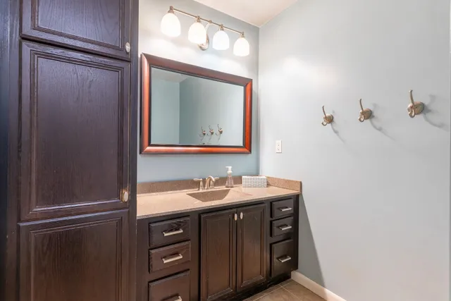 a bathroom with a sink vanity and a mirror