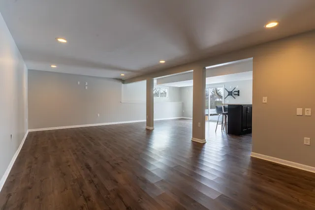 a view of empty room with wooden floor