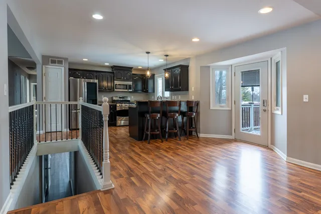 a view of a kitchen with dining room wooden floor and furniture