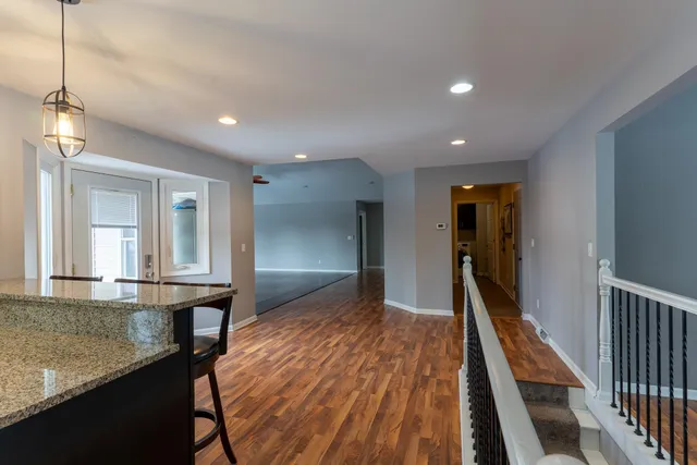 a view of hallway with wooden floor