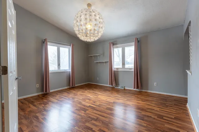 a view of a kitchen area with furniture and wooden floor