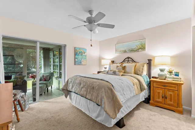 a bedroom with a bed and ceiling fan