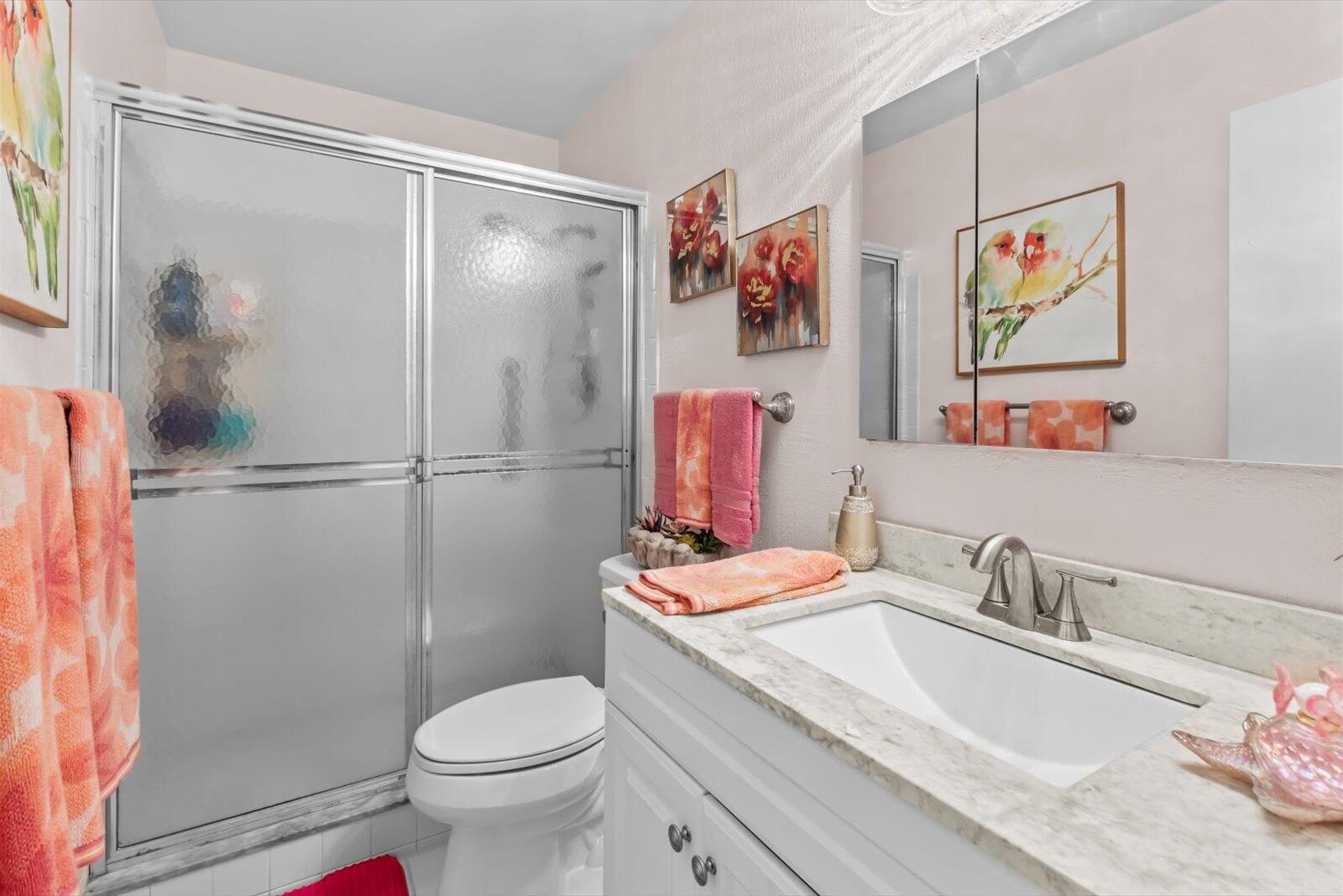 2929 Southeast Ocean Boulevard, Unit 1309 Stuart, FL 34996 - Photo 14 of 29 a bathroom with a sink toilet and shower