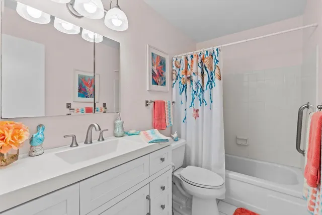 a bathroom with a sink a toilet and a shower curtain