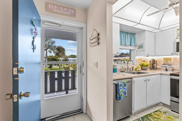 a utility room with cabinets washer and dryer