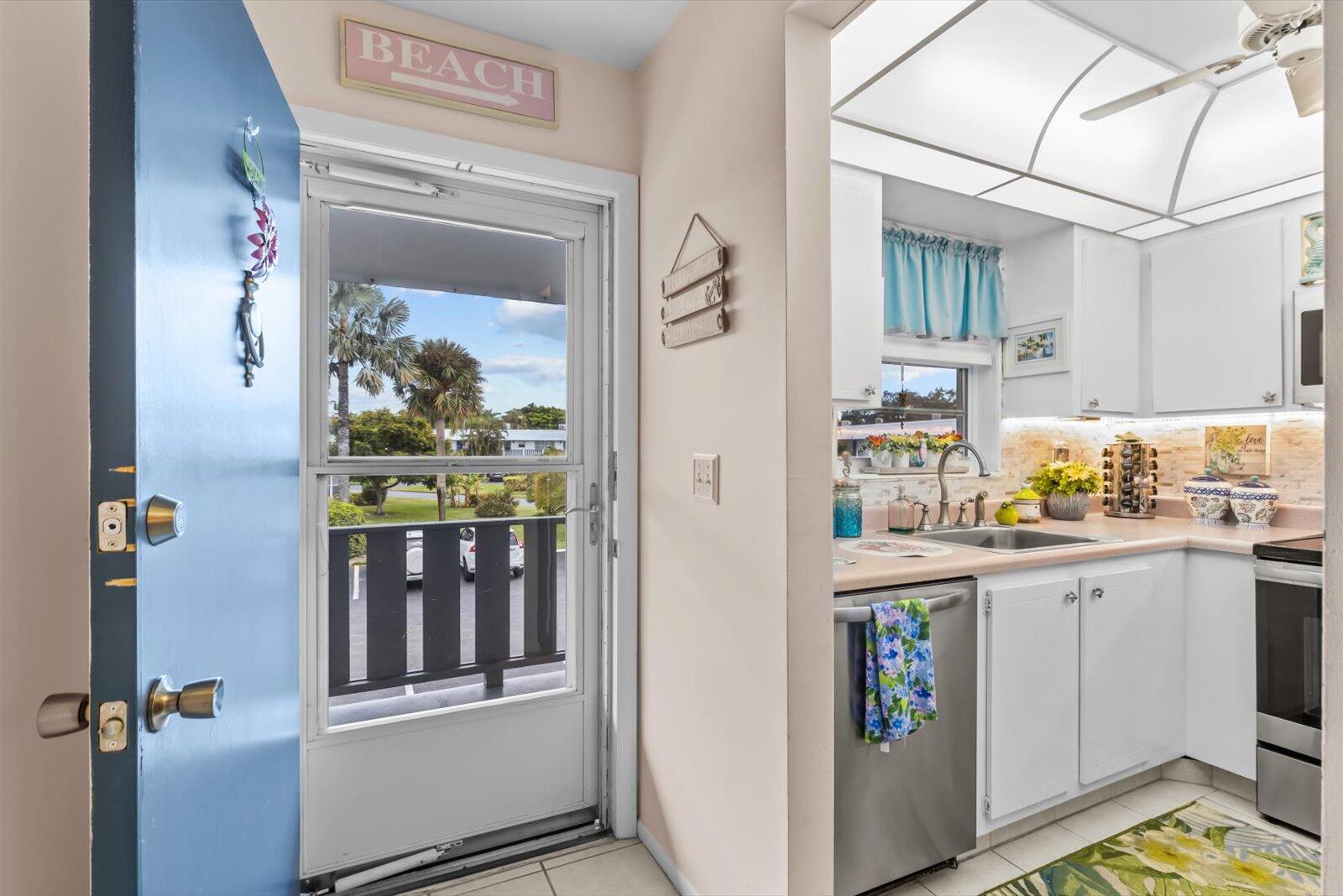 2929 Southeast Ocean Boulevard, Unit 1309 Stuart, FL 34996 - Photo 2 of 29 a utility room with cabinets washer and dryer