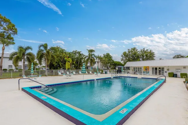 a view of a swimming pool with outdoor seating