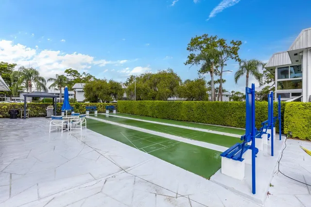 a view of a park with couches and wooden fence