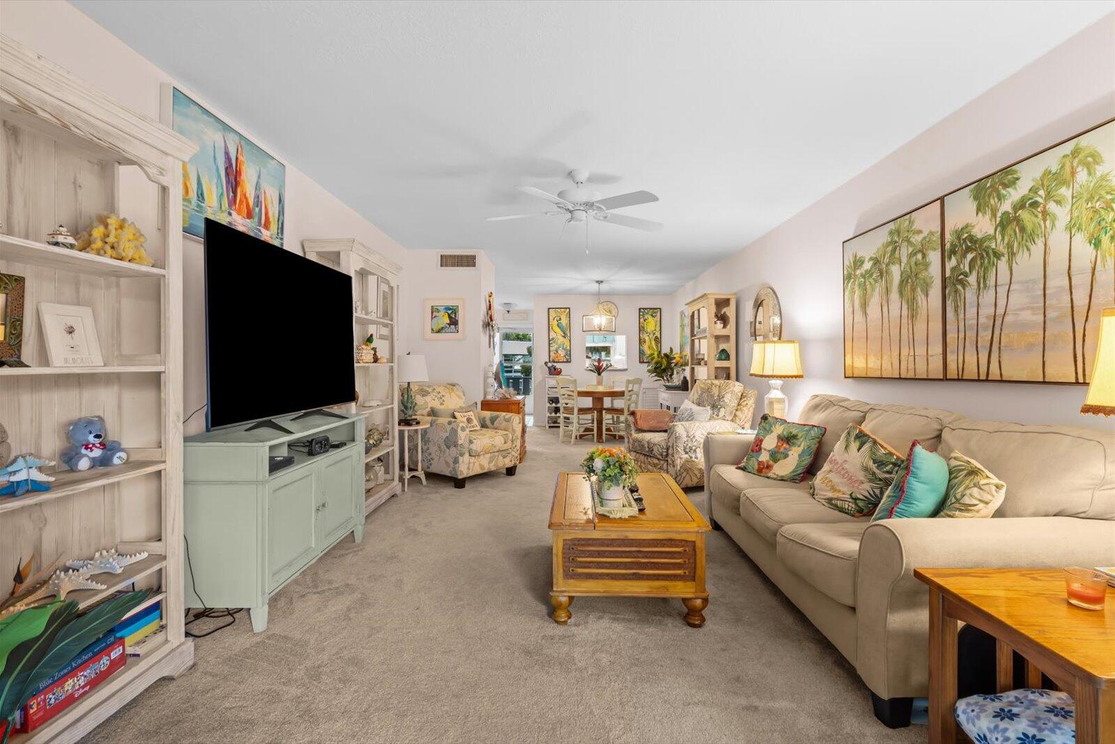2929 Southeast Ocean Boulevard, Unit 1309 Stuart, FL 34996 - Photo 7 of 29 a living room with furniture and a flat screen tv