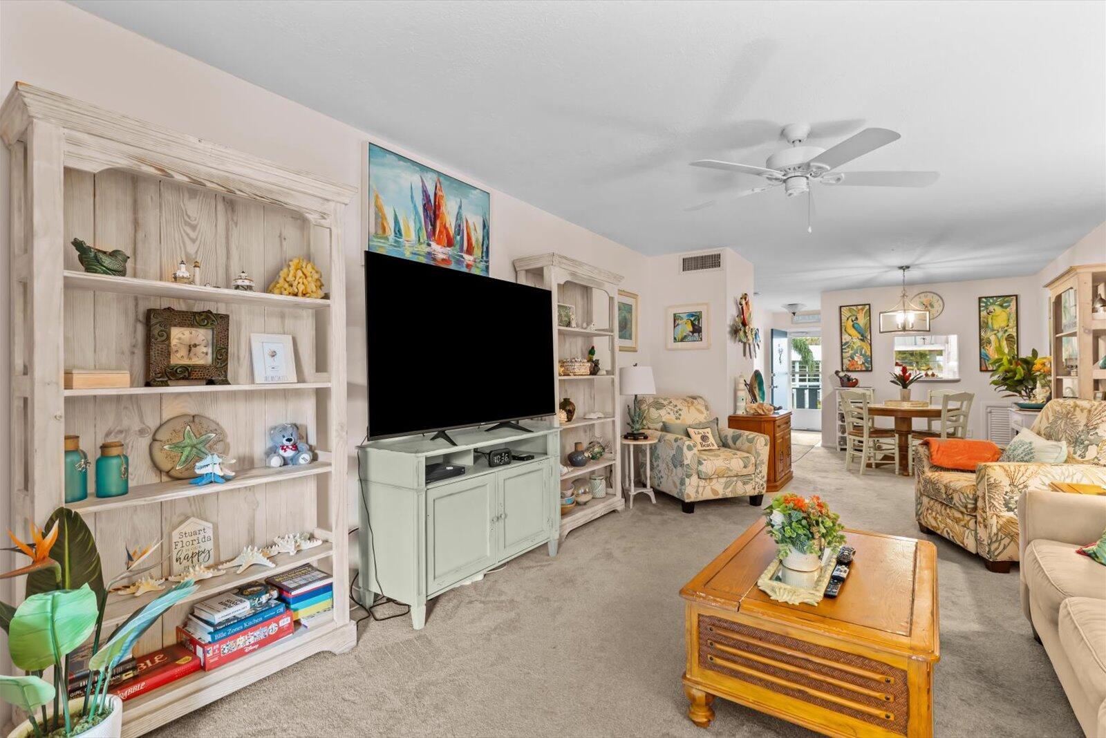 2929 Southeast Ocean Boulevard, Unit 1309 Stuart, FL 34996 - Photo 8 of 29 a living room with furniture and a flat screen tv
