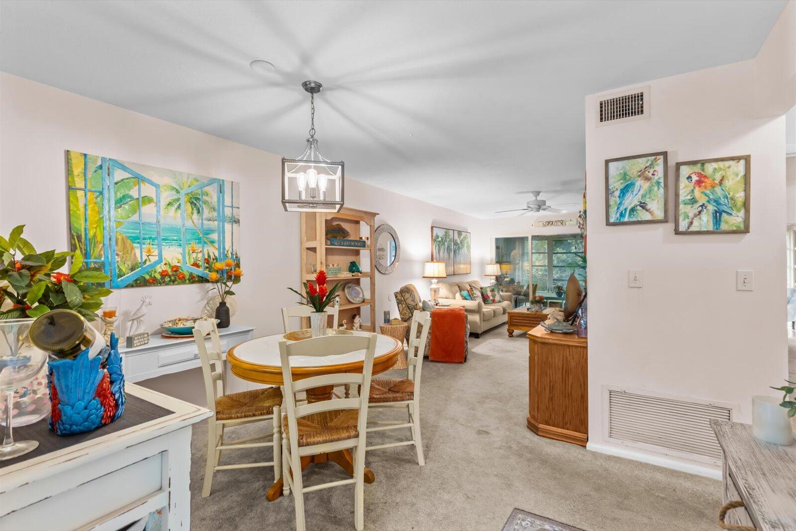 2929 Southeast Ocean Boulevard, Unit 1309 Stuart, FL 34996 - Photo 10 of 29 a view of a dining room with furniture a chandelier and window