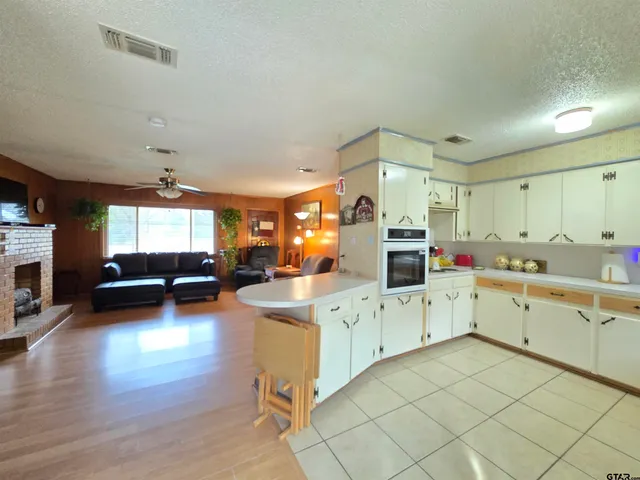 a kitchen with cabinets a sink and a stove top oven