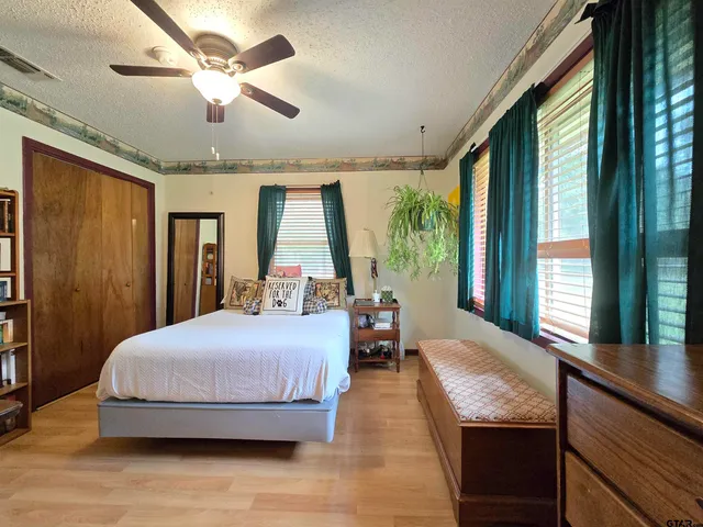 a bedroom with a large bed and a large window