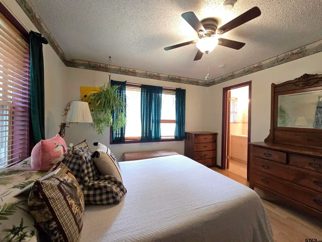 a bedroom with a bed and a large window