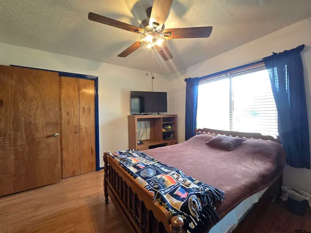 a bedroom with a bed and a chandelier