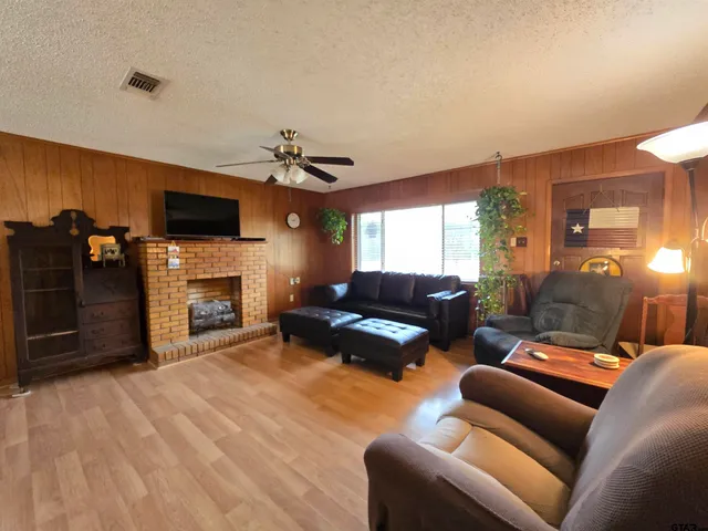 a living room with furniture a flat screen tv and a fireplace