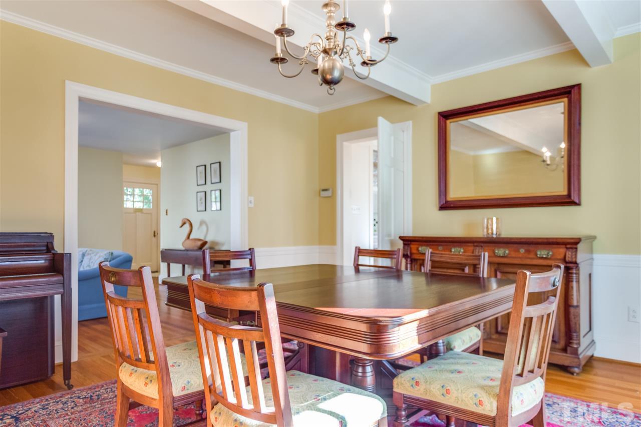 2514 Beechridge Road Raleigh, NC 27608 - Photo 14 of 25 a dining room with wooden floor and chandelier