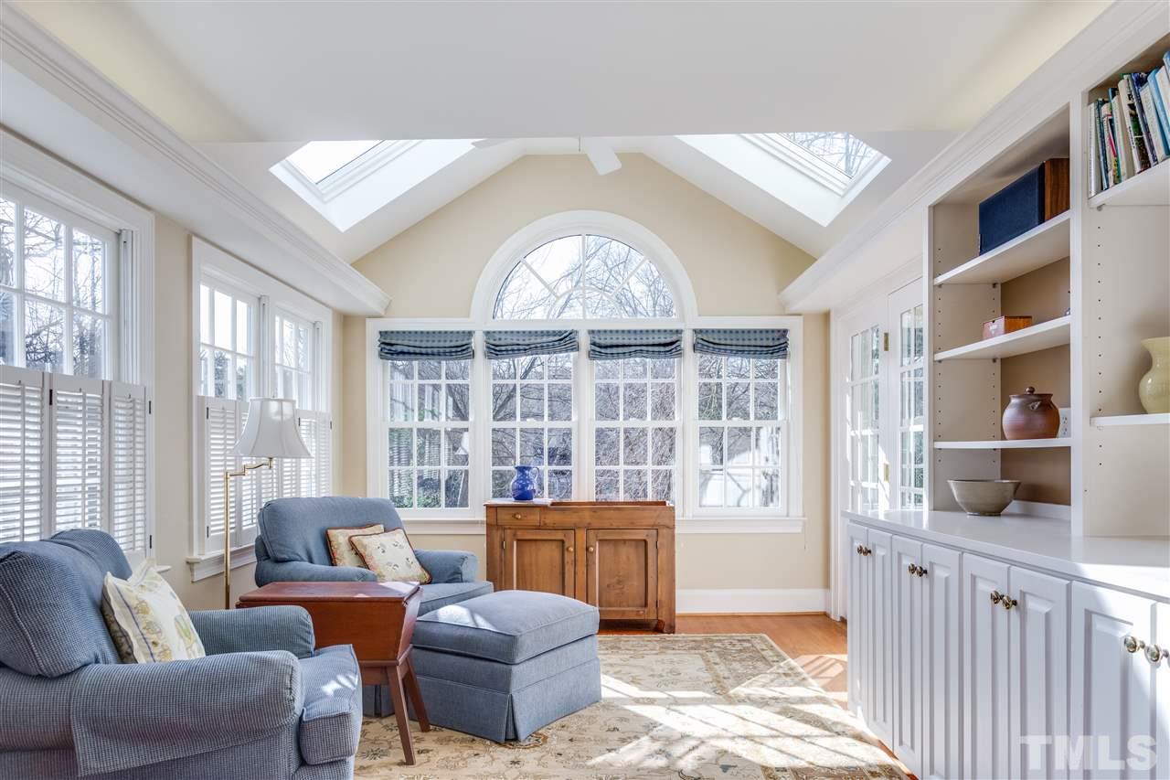 2514 Beechridge Road Raleigh, NC 27608 - Photo 15 of 25 a living room with furniture and a floor to ceiling window